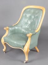 A Victorian bleached mahogany show frame armchair upholstered in turquoise buttoned leather, the