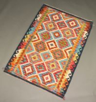 A white, orange and turquoise ground Chobi Kilim with all over geometric design 157cm x 105cm