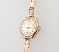 A lady's Strad wristwatch contained in a 9ct gold case with integral bracelet, case including