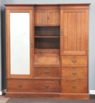 A Victorian mahogany break front double wardrobe with shaped and moulded cornice, the centre hanging