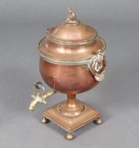 A Regency copper twin handled tea urn with dolphin finial on square base with bun feet 48 cm x
