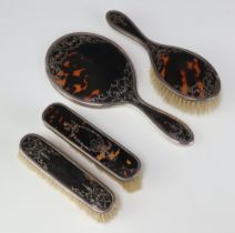 A matched silver and tortoiseshell 4 piece dressing table set comprising hand mirror, hair brush and