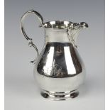 A Victorian engraved silver cream jug of baluster form London 1873 by Richard Brown (Charles Brown),