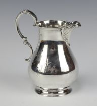 A Victorian engraved silver cream jug of baluster form London 1873 by Richard Brown (Charles Brown),