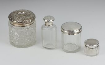 A cylindrical cut glass hair tidy with embossed silver lid (marks rubbed) 8cm, a faceted glass