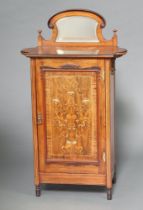 An Edwardian heavily inlaid mahogany music cabinet with raised arched mirrored back, fitted
