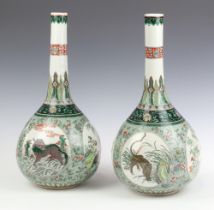 A pair of 19th Century Chinese famille vert porcelain club shaped vases of panelled decoration,
