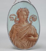An oval painted glass panel decorated a classical lady feeding birds, contained within a lead
