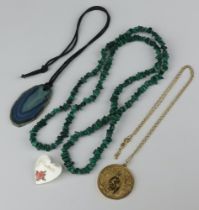 A malachite coloured string of beads, a gilt metal pendant and a polished hardstone pendant