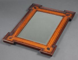 A Victorian beveled plate mirror contained in a mahogany and crossbanded frame with mitred corners