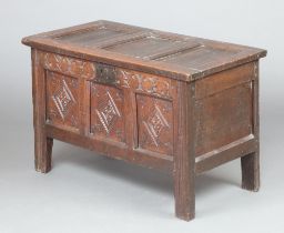 A 17th/18th Century coffer of carved panelled construction with original ring rings, the interior