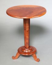 A Victorian figured mahogany circular wine table raised on a tapered chamfered column, circular base