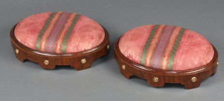 A pair of Regency oval walnut and gilt studded footstools with drop in seats 10cm x 38cm x 27cm