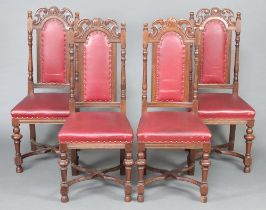 A set of 4 Edwardian oak Carolean style high back chairs raised on turned supports with X framed