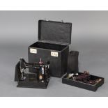 A 1951 Singer Featherweight electric sewing machine complete with foot control, bobbins, etc and