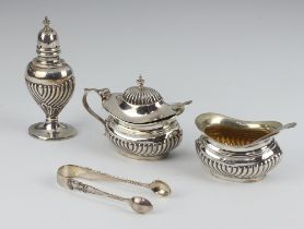 An Edwardian 3 piece silver condiment set with demi-reeded decoration - salt, pepper and mustard pot