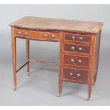 An Edwardian inlaid mahogany desk with inset brown writing surface above 1 long and 4 short drawers,