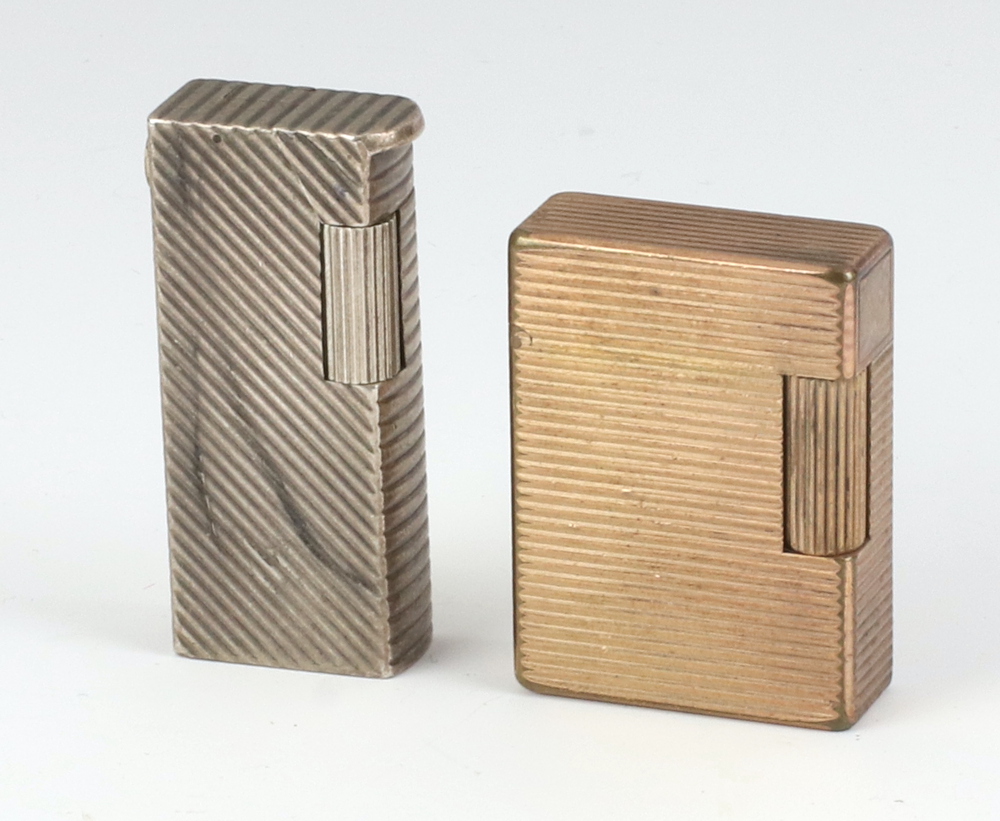 A silver plated Dunhill lighter (roller stuck) together with a Dupont gold plated lighter