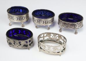 A pair of Georgian pierced silver salts with blue glass liners, London 1790 (1 with crack to base, 1