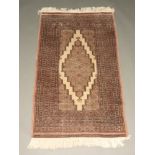 A grey and brown ground Bokhara rug with multi row border 155cm x 193cm Some wear in places