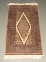 A grey and brown ground Bokhara rug with multi row border 155cm x 193cm Some wear in places