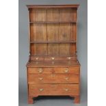 An 18th Century oak dresser, the raised back with moulded cornice fitted 2 shelves above 3 long