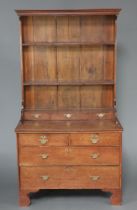 An 18th Century oak dresser, the raised back with moulded cornice fitted 2 shelves above 3 long