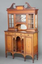 An Edwardian inlaid mahogany display cabinet with pierced broken pediment, the upper section