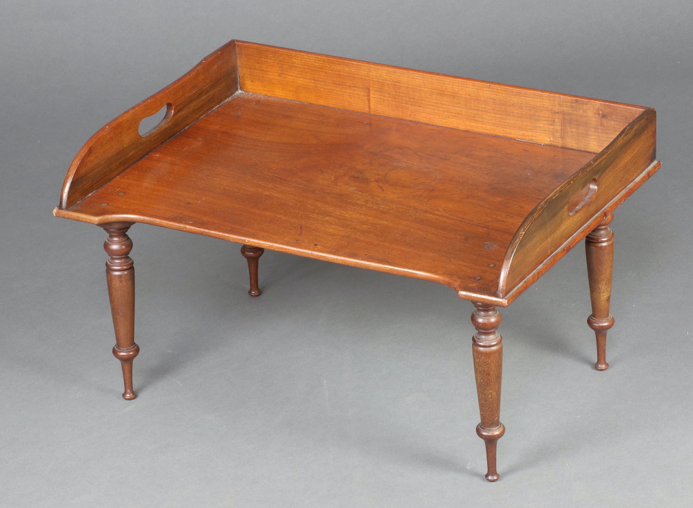 A Victorian mahogany bed tray with three quarter gallery raised on turned supports 34cm h x 60cm w x