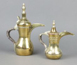 An engraved brass Arabic Dallah coffee pot with crescent mark 22cm x 7cm together with a plain ditto