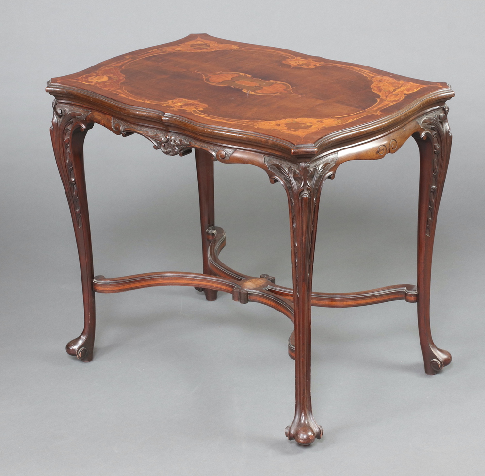 A Victorian shaped and carved inlaid mahogany occasional table raised on cabriole supports with X