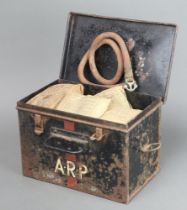 A Second World War ARP First Aid tin containing a tourniquet, five first field dressings, 5 shell