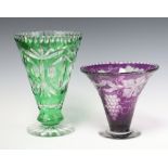 A Bohemian green glass trumpet shaped vase, raised on a spreading foot 26cm together with a purple