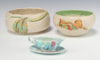 A Clarice Cliff circular bowl 20cm, 1 other with floral decoration 19cm and a sauce boat and