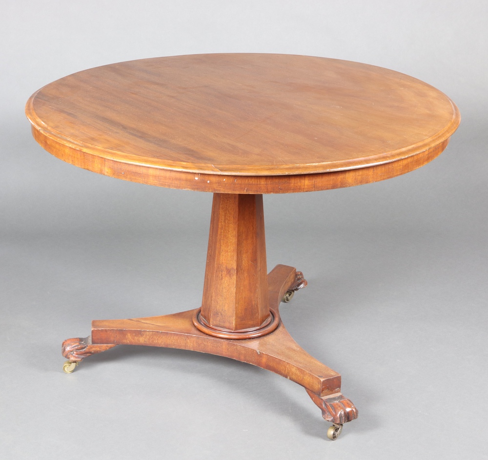 A William IV circular mahogany snap top Loo table raised on chamfered column, triform base and