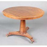 A William IV circular mahogany snap top Loo table raised on chamfered column, triform base and