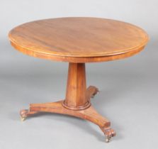 A William IV circular mahogany snap top Loo table raised on chamfered column, triform base and