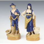 A pair of Royal Dux bisque porcelain spill vases in the form of a standing boy and girl, the base