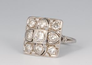A white metal square dress ring set diamonds, the centre diamond approx. 0.4ct, the surrounding