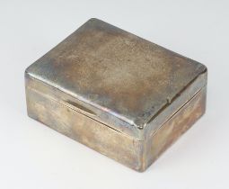 A plain silver cigarette box with hinged lid London 1922 5cm x 11cm x 9cm Dents in places