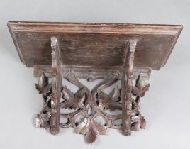 A Victorian carved oak bracket with vinous decoration 23cm h x 39cm w x 21cm d