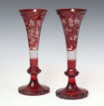 A pair of Bohemian red overlay glass trumpet shaped vases decorated stags 30cm Chips to base