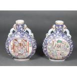 A pair of large and impressive 20th Century Chinese pottery moon shaped flasks decorated courtly