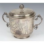 An impressive engraved silver cup and cover with floral and warrior decoration, London 1928, 1292