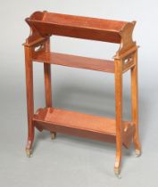 An Edwardian rectangular mahogany twin section book trough, raised on standard end supports with