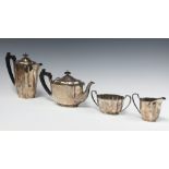 An oval silver 4 piece tea service comprising teapot, hot water jug, twin handled cream jug and