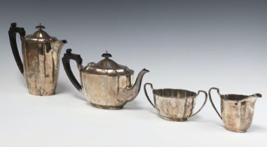 An oval silver 4 piece tea service comprising teapot, hot water jug, twin handled cream jug and