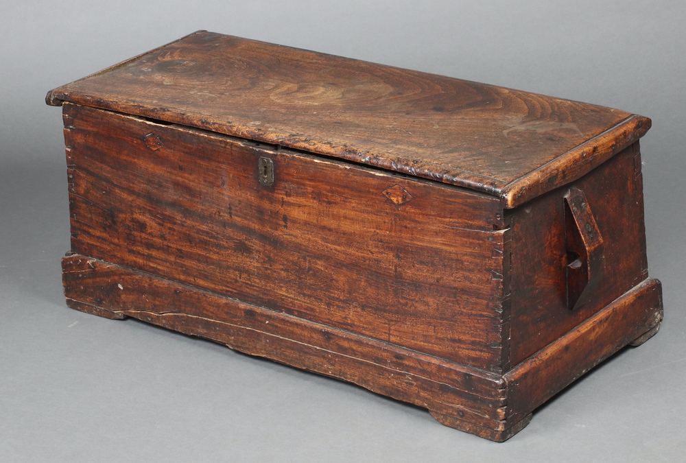 An 18th Century elm coffer of tapered form and hinged lid 42cm h x 96cm w x 41cm d Top is warped,