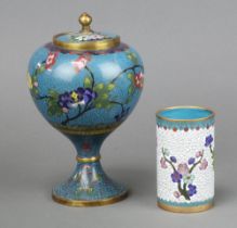A Japanese cloisonne blue ground globular shaped jar and cover, raised on a waisted column decorated