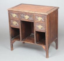 A Victorian carved oak desk with inset writing surface, fitted 5 drawers above 3 recesses 75cm h x